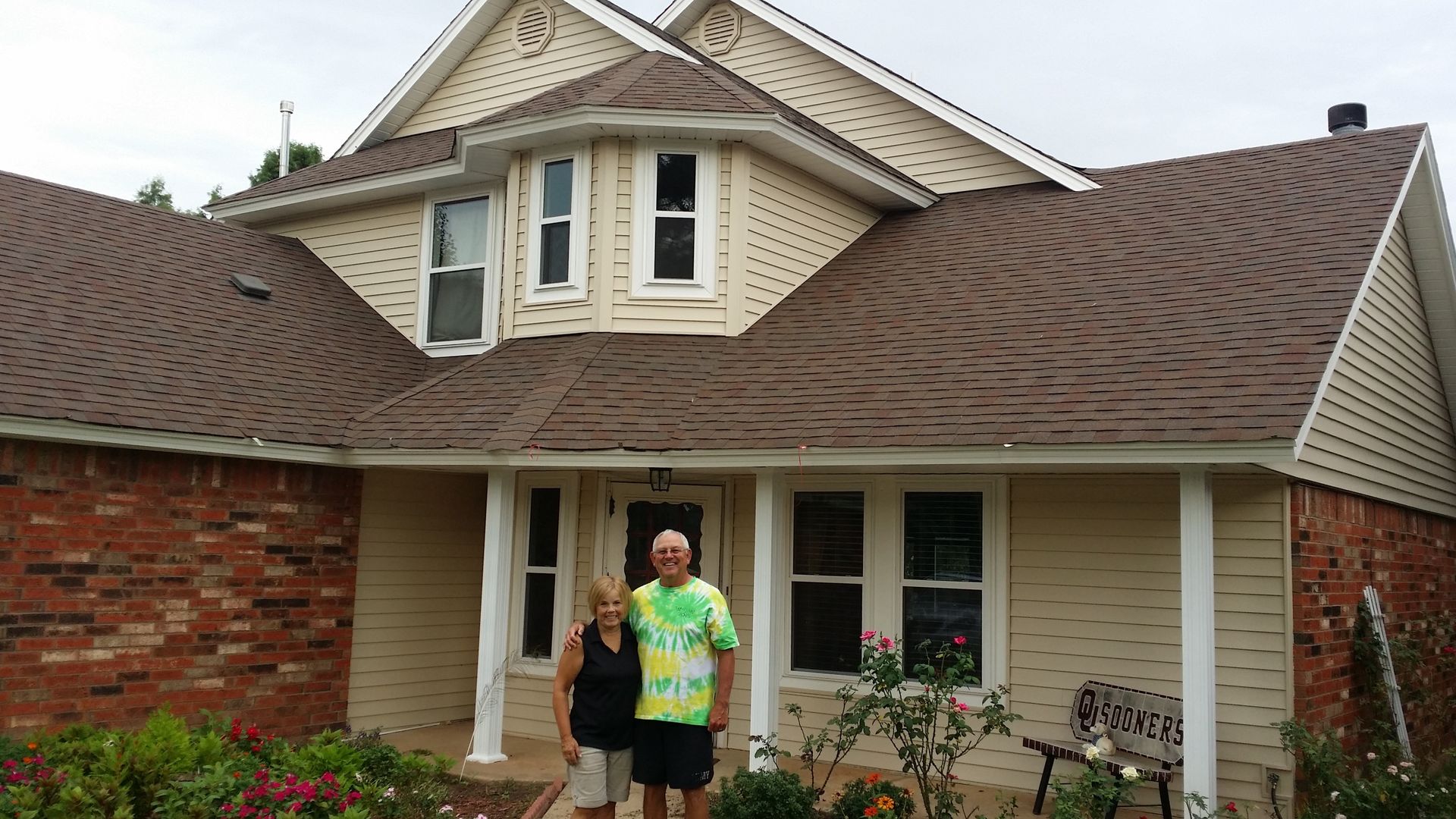 Homeowners standing in front of a completed exterior project